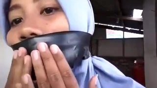 Hijab wrap gagged with black tape