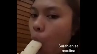 Asian girl sucking banana for fun